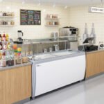 Coldline DP-560-FSG 71'' 12-Tub Ice Cream Dipping Cabinet Freezer with Sneeze Guard